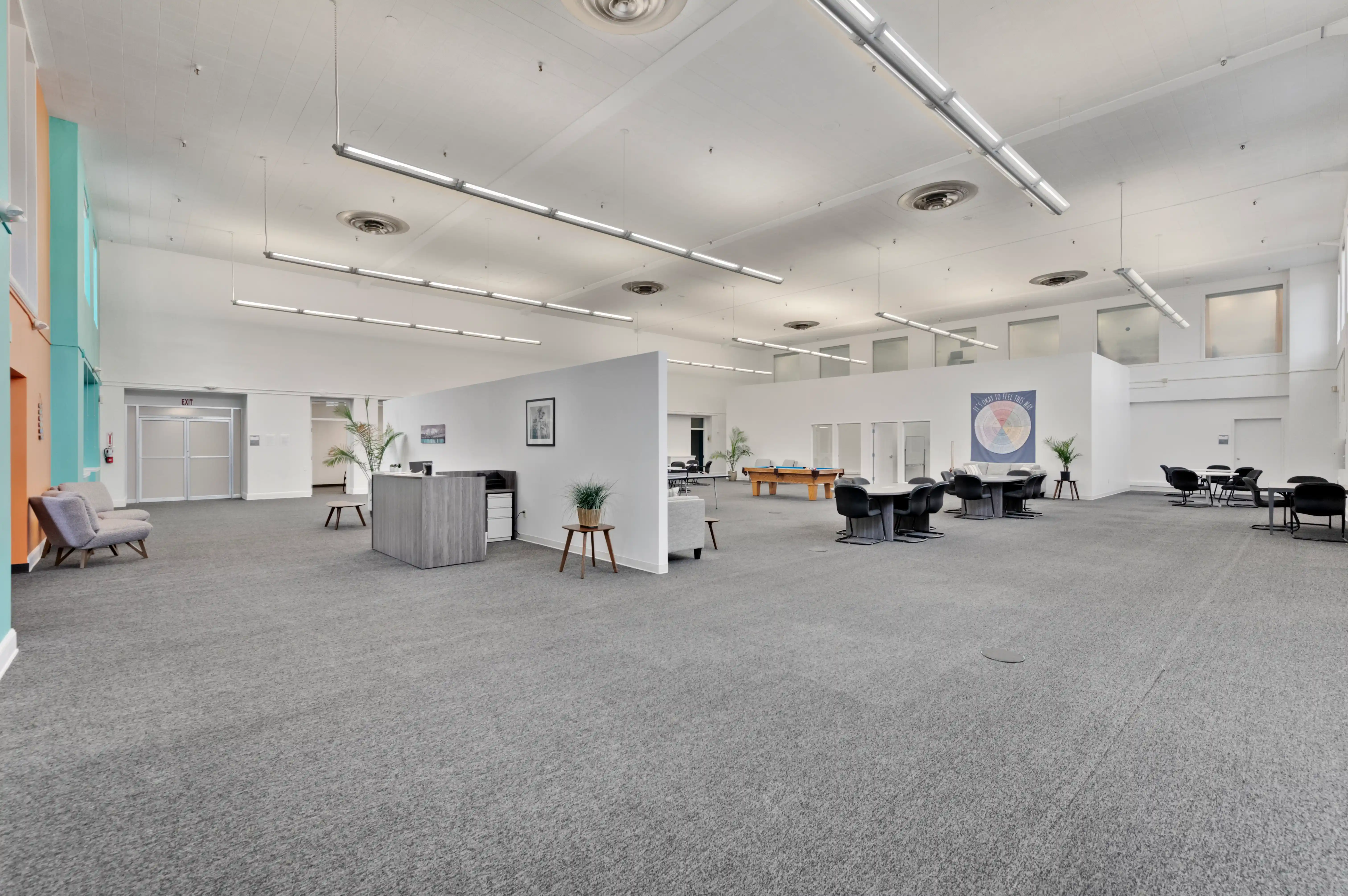 Wide view of Atlas Treatment Center interior showing reception, activity area, and community space
